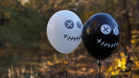 White and black inflatable balloons with scary Halloween faces on the background Stock Footage 150296110