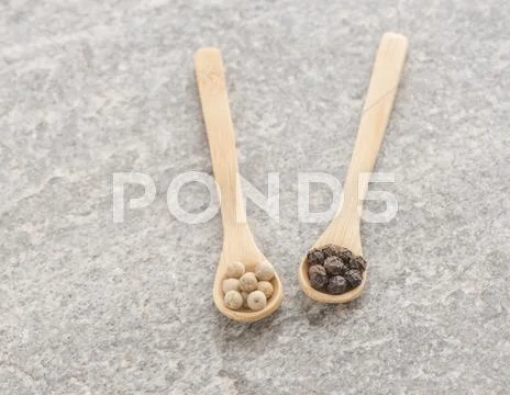 White And Black Pepper Corns On Wooden Spoon, Spicy Seasoning.