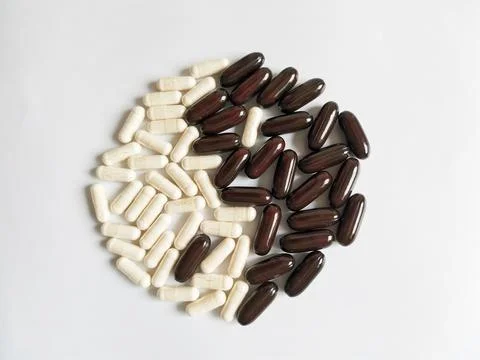 White and black tablets in the form of the yin-yang sign Stock Photos