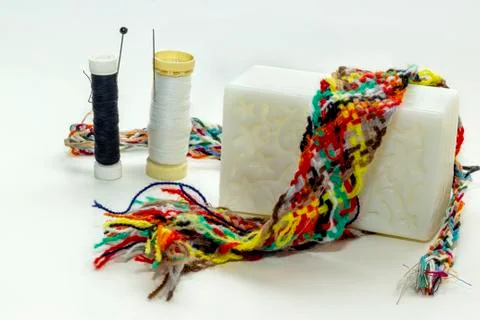 White and black thread spool, soap, sewing needle Stock Photos