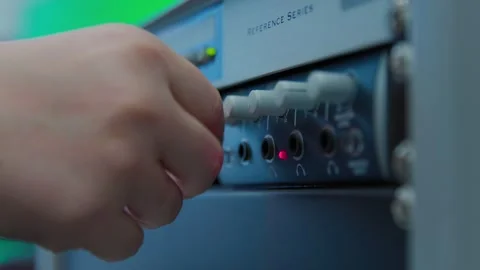 A white and blue electronic device with a red light on it controlled Stock Footage 276662511