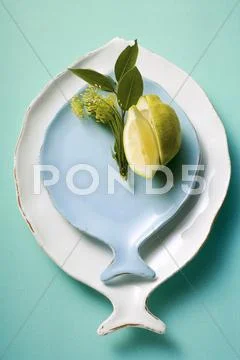 White and blue fish plates, decorated with lemon Stock Photos