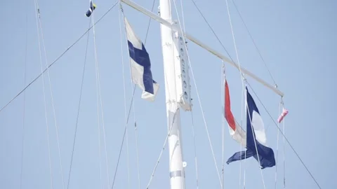A white and blue flag is hanging from a mast Stock Footage 302467221