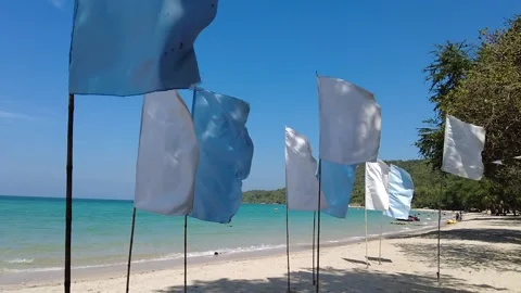 White and blue Flags on a beach in Thailand - SLOWMOTION Stock Footage 148282682