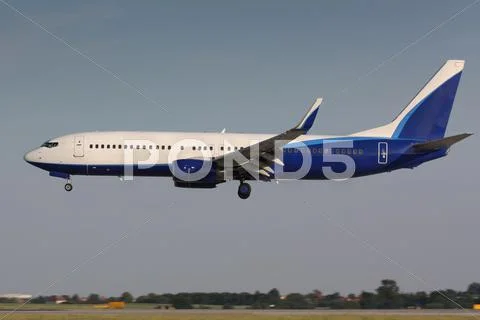 White and blue landing plane Stock Photos