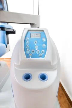 A white and blue machine with two holes used for medical equipment Stock Photos