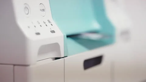 A white and blue printer with a green handle Video stock 344908758