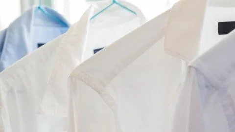 White and blue shirts at a dry cleaners Stock Photos