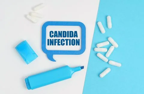 On a white and blue table are pills, a marker and a blue plaque with the insc Stock Photos