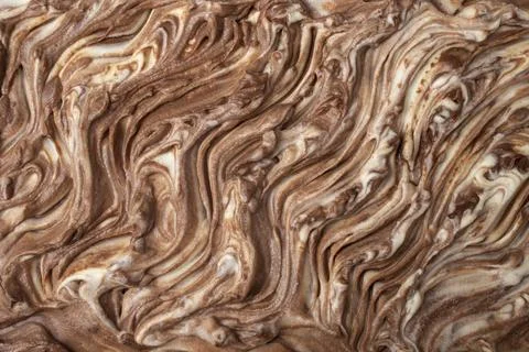 White and brown chocolate cream swirls on a birthday cake, top view abstrac.. Stock Photos