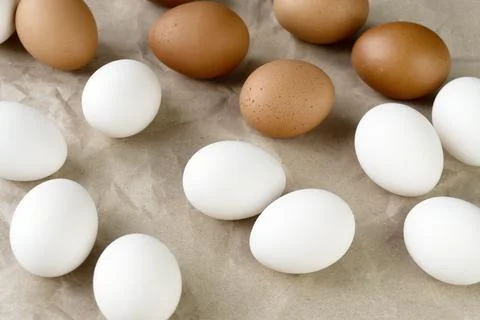 White and brown eggs on the table. View from above Stock Photos