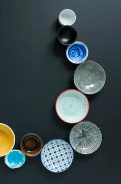 White and coloured tableware on black background Foto stock