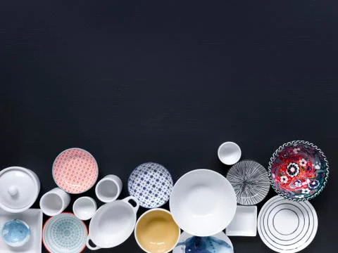 White and coloured tableware on black background Foto stock