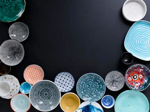 White and coloured tableware on black background Foto stock