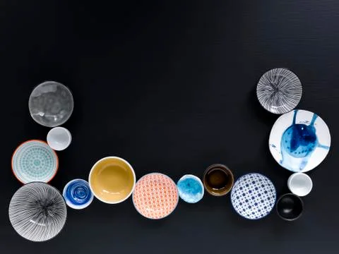 White and coloured tableware on black background Fotos de archivo