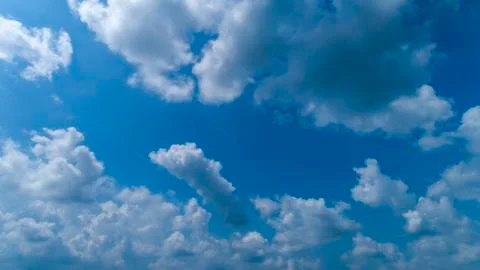 White and Dark Clouds Floating in the Bright Blue Skies Stock Photos