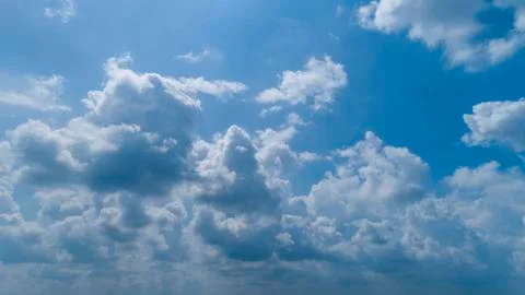 White and Dark Clouds Floating in the Bright Blue Skies Stock Photos