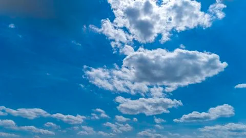 White and Dark Clouds Floating in the Bright Blue Skies Stock Photos
