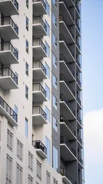 White and gray building with multiple balconies coming out of each floor Stock-Fotos