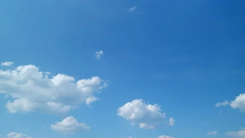 White and gray clouds fly across the sky and change shape. Timelapse. Stock Footage 216084998