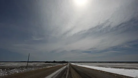 White and gray clouds moving through a blue spring sky about a prairie setting  Stock Footage 151532804
