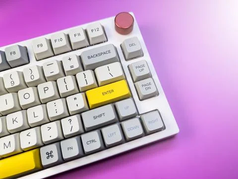 White and gray keyboard for programmer, on a purple background with a red button 스톡 사진