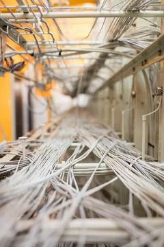 White and gray network cables are stretching along metal trays in 3D render Foto stock