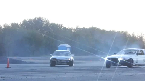 White and grey car drift side by side on race course at drifting event. Stock-Footage 59762224