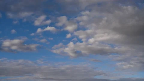 White and grey clouds drifting from right to left through a blue sky. Stock Footage 150117056