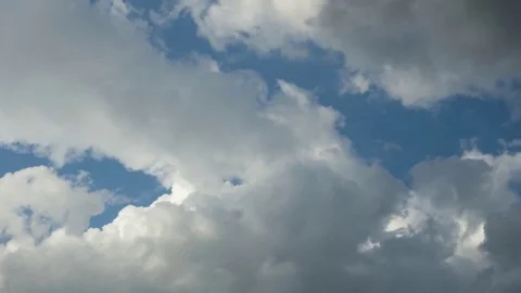 White and grey clouds passing by through a beautiful blue sky, time lapse Stock Footage 77833033