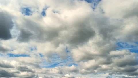 White and grey fluffy clouds rolling against clear vibrant blue sky Stock Footage 115328103
