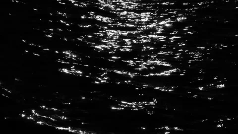 White and  light reflecting off of black water. Sparkal and glistening. Stock Footage 131564596