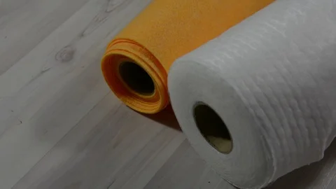 White and orange rolls of paper towels on a light floor. Stock Footage 123714195