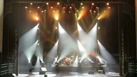 White and orange spotlights on stage with musical instruments before the concert Stock Footage 100325968