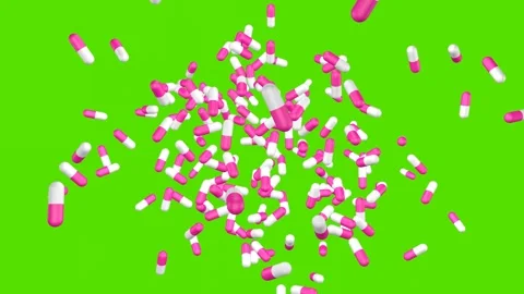 White and pink capsules explode and fly apart on green screen. Stock Footage 279765194