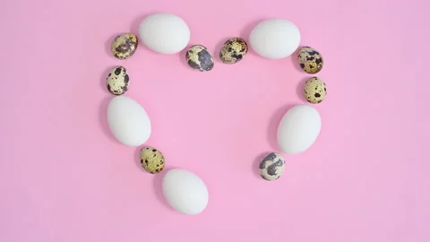 White and quail eggs make heart shape on pink background. Easter stop motion Stock-Footage 171448582