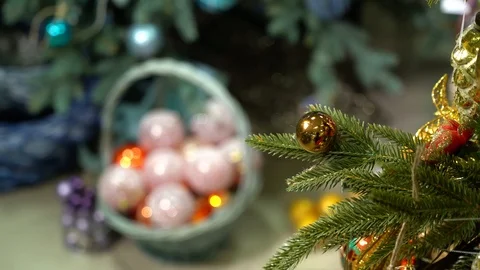 White and red balls in a white basket under the tree, transition to a close-up Stock Footage 119958874