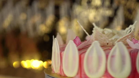 A white and red biscuit cake is sold by spinning in a display case Stock Footage 234825506