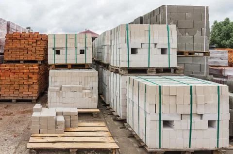 White and red bricks folded on pallets Stock Photos