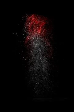 White and red dust explosion isolated on black background Stock Photos
