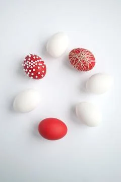 White and red easter eggs laid out in a circle on a white background Stock Photos