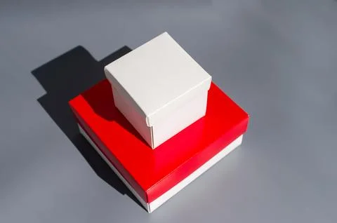 White and red gift boxes on gray background with shadow Stock Photos