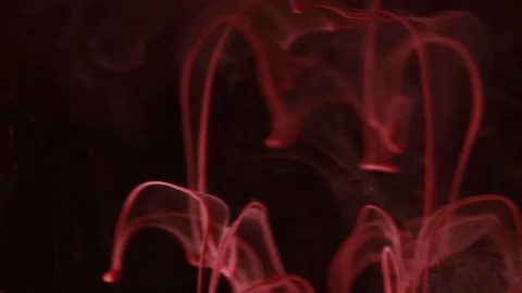 White and red paint mixed on a black background Stock Footage 85843459
