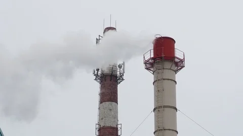 White and red pipe thick white smoke is poured from the factory. Pollution of th Stock Footage 123950238