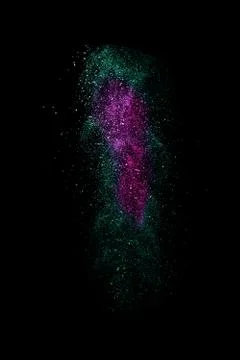 White and violet dust explosion isolated on black background Stock Photos