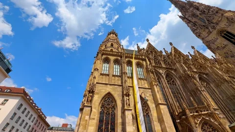 White and yellow flag hanging from the façade of Saint Stephen's Cathedral. Stock Footage 312957154