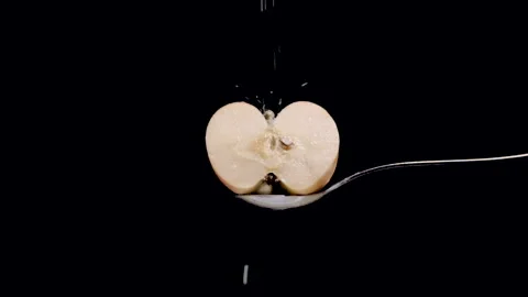 White apple cut in half with sugar dripping in slow motion Stock Footage 131406239