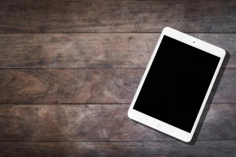 A white apple ipad tablet with blank screen on wooden table Stock Photos