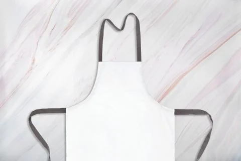 White apron on natural marble pattern background. Close-up of white aparon on Foto stock