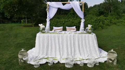 White arch and wedding table covered with white. Stock Photos